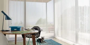 White vertical blinds on large windows in home office.