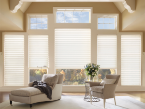 Hunter Douglas Solera Roman Shades in white on living room windows.