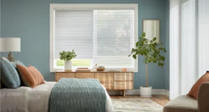 White blinds and shades on window in bedroom.