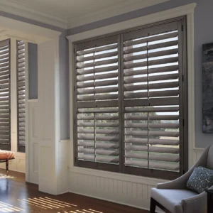 Dark wooden plantation shutters on a living room window.