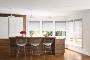 Grey patterned roller shades on windows in kitchen.