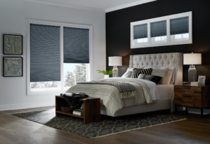 Blue cellular shades on the windows of a bedroom.