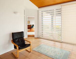 Norman banded shades in white on large living room window.