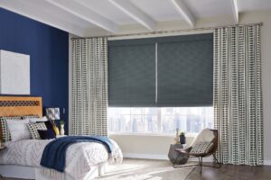 Roller shades and automated drapery and curtains in bedroom